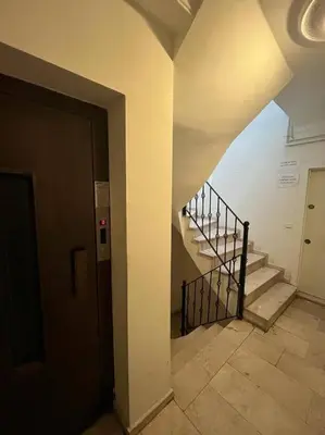 a hallway with a staircase in a building at Prime location with terrace in Istanbul