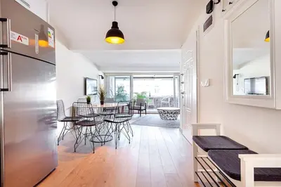 a kitchen and dining room with a table and a refrigerator at Prime location with terrace in Istanbul