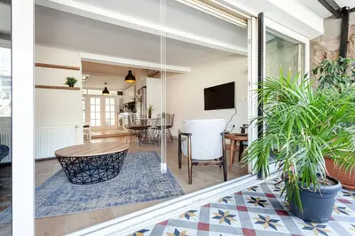a living room with a table and some plants at Prime location with terrace in Istanbul