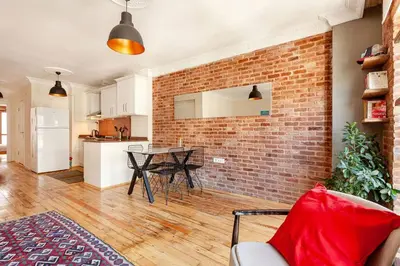 a living room with a brick wall and a table at Central location with 2 bedrooms in Istanbul