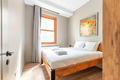 a bedroom with a bed with white sheets and a window at Stunning Bright Central Modern 1BD Balat Gem! #328 in Istanbul