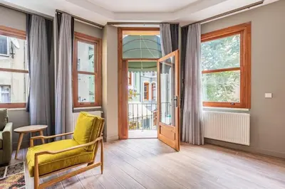 a living room with a yellow chair and a door at Stunning Bright Central Modern 1BD Balat Gem! #328 in Istanbul