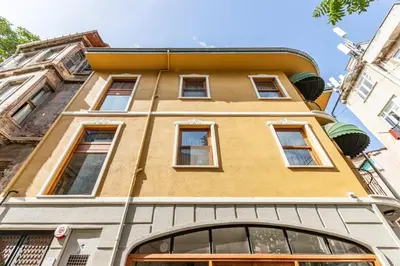 a yellow building with windows on a street at Stunning Bright Central Modern 1BD Balat Gem! #328 in Istanbul