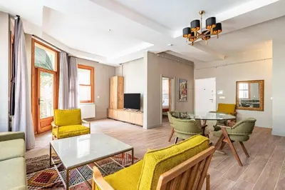 a living room with a table and yellow chairs at Stunning Bright Central Modern 1BD Balat Gem! #328 in Istanbul