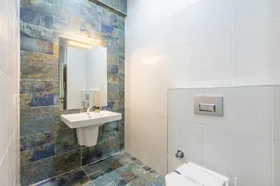 a bathroom with a sink and a toilet and a mirror at Stunning Bright Central Modern 1BD Balat Gem! #328 in Istanbul