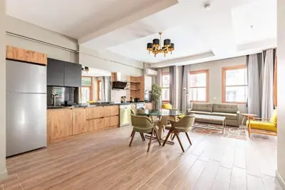 a kitchen and living room with a table and chairs at Stunning Bright Central Modern 1BD Balat Gem! #328 in Istanbul
