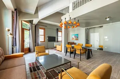 a living room with a couch and a table and chairs at Beautiful Bright Cool Modern 1BD Balat Loft! #329 in Istanbul