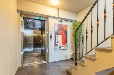 a hallway with a staircase leading to a elevator at Beautiful Bright Cool Modern 1BD Balat Loft! #329 in Istanbul
