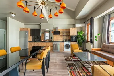 a kitchen with a glass table and yellow chairs at Beautiful Bright Cool Modern 1BD Balat Loft! #329 in Istanbul