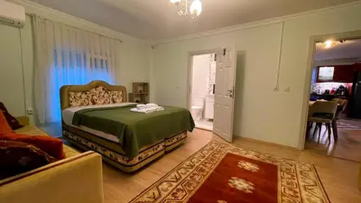 a bedroom with a bed and a living room at Bizim Ev in Sapanca