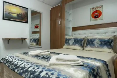 a bedroom with a bed with towels on it at Koçak Pansiyon in Istanbul