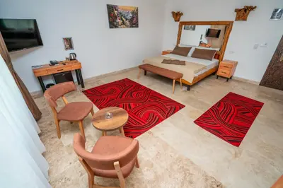 a living room with a bed and a table and chairs at PASHA PALACE HOTEL in Istanbul
