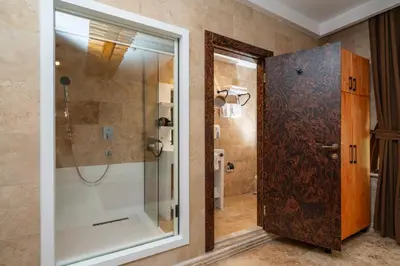 a bathroom with a shower and a glass door at PASHA PALACE HOTEL in Istanbul