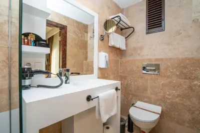 a bathroom with a sink and a toilet at PASHA PALACE HOTEL in Istanbul