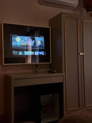 a flat screen tv sitting on top of a fireplace at HaciBayramApart in Istanbul
