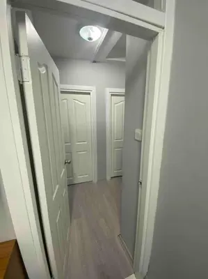 an empty room with a hallway with white doors at Kadıköy Miski Amber in Istanbul