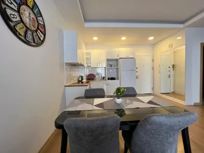 a kitchen with a dining room table and chairs at Cozy Home 1 Room 1 Living Room Apartment in Esenyurt