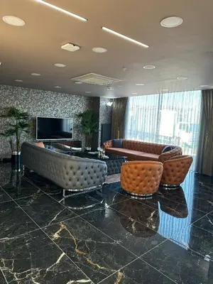 a lobby with couches and a flat screen tv at Asgard Hotel in Beylikduzu