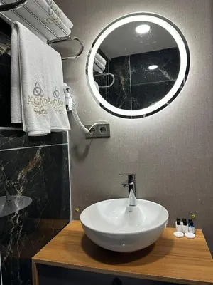 a bathroom with a white sink and a mirror at Asgard Hotel in Beylikduzu
