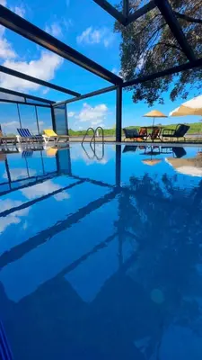 a pool with chairs and umbrellas in the background at Green Roof Boutique Hotel & SPA Istanbul Airport in Terkos