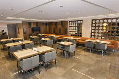 a restaurant with tables and chairs and a wine cellar at Fesa Business Hotel in Gebze