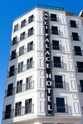 a white building with a hotel sign on it at Avcı Palace Hotel in Istanbul