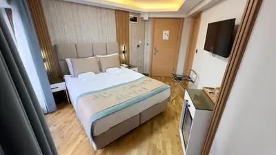 a hotel room with a bed and a television at Avcı Palace Hotel in Istanbul