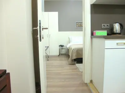a room with a hallway with a bed and a door at Stay Juno in Istanbul