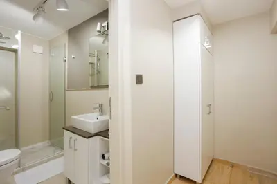 a white bathroom with a sink and a toilet at Stay Juno in Istanbul