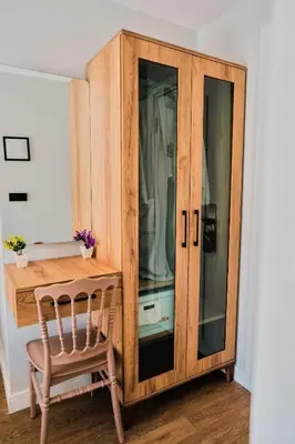 a wooden cabinet with a chair next to a desk at Taksim Santa Lucia Hotel in Istanbul
