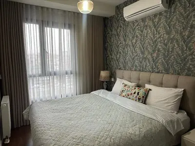 a bedroom with a large bed and a window at 4+1 daire in Istanbul