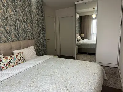a bedroom with a large bed and a mirror at 4+1 daire in Istanbul