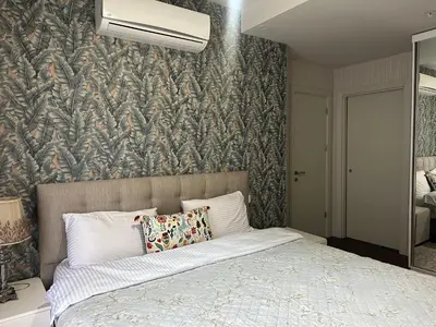 a bedroom with a large bed with a wall at 4+1 daire in Istanbul