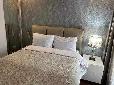 a bedroom with a bed and a lamp on a nightstand at 4+1 daire in Istanbul