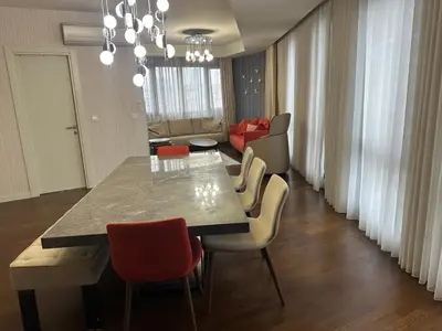 a dining room with a table and chairs and a couch at 4+1 daire in Istanbul