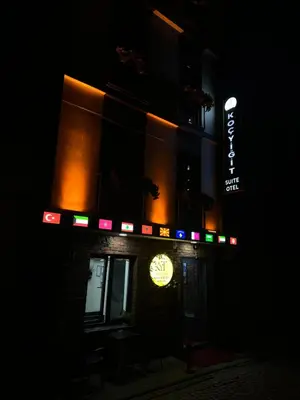 a building with a neon sign on the side of it at night at Koçyiğit Suite & Hotel in Istanbul