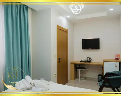 a hotel room with a bed and a desk and a television at Koçyiğit Suite & Hotel in Istanbul