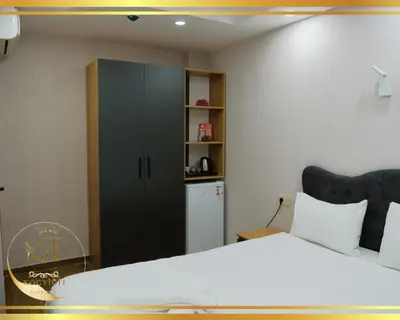 a bedroom with a large bed and a cabinet at Koçyiğit Suite & Hotel in Istanbul