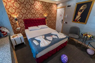 a bedroom with a bed and a table and a chair at Stay Suite Hotel in Istanbul
