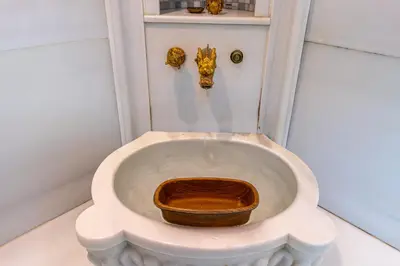 a white toilet with a wooden seat in a bathroom at Stay Suite Hotel in Istanbul