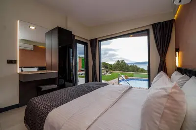 a bedroom with a large bed and a large window at Lake Look Sapanca in Sapanca