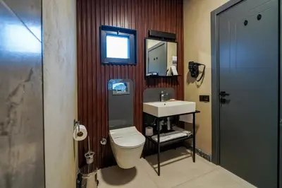 a bathroom with a toilet and a sink and a mirror at Lake Look Sapanca in Sapanca