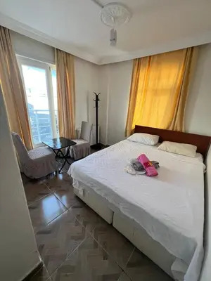 a bedroom with a large bed with a pink bag on it at Airport Confort Guest House in Arnavutköy