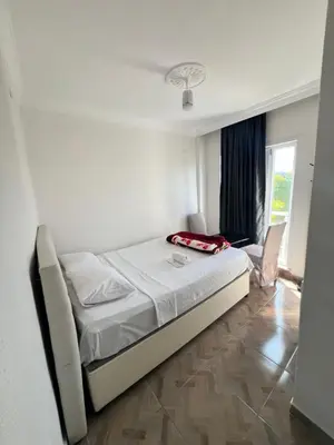 a small bedroom with a bed and a window at Airport Confort Guest House in Arnavutköy