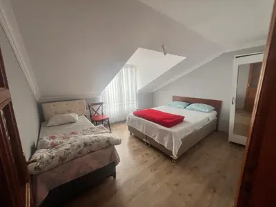 a bedroom with two beds and a window at Airport Confort Guest House in Arnavutköy