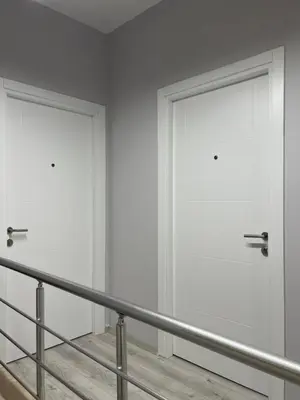 two white doors in a room with a staircase at Galata Inn Hotel in Istanbul