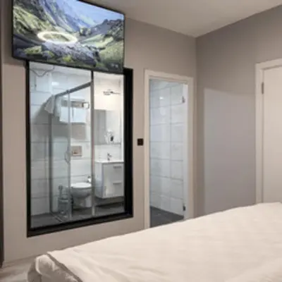 a bedroom with a large mirror on the wall at Galata Inn Hotel in Istanbul