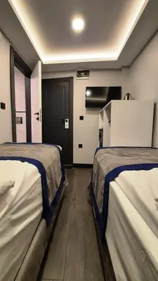 a room with two beds and a door at SAND DOOR HOTEL in Istanbul
