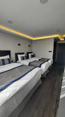 a row of four beds in a room at SAND DOOR HOTEL in Istanbul