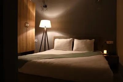a bedroom with a large bed with a lamp at Cibali Hotel Istanbul in Istanbul